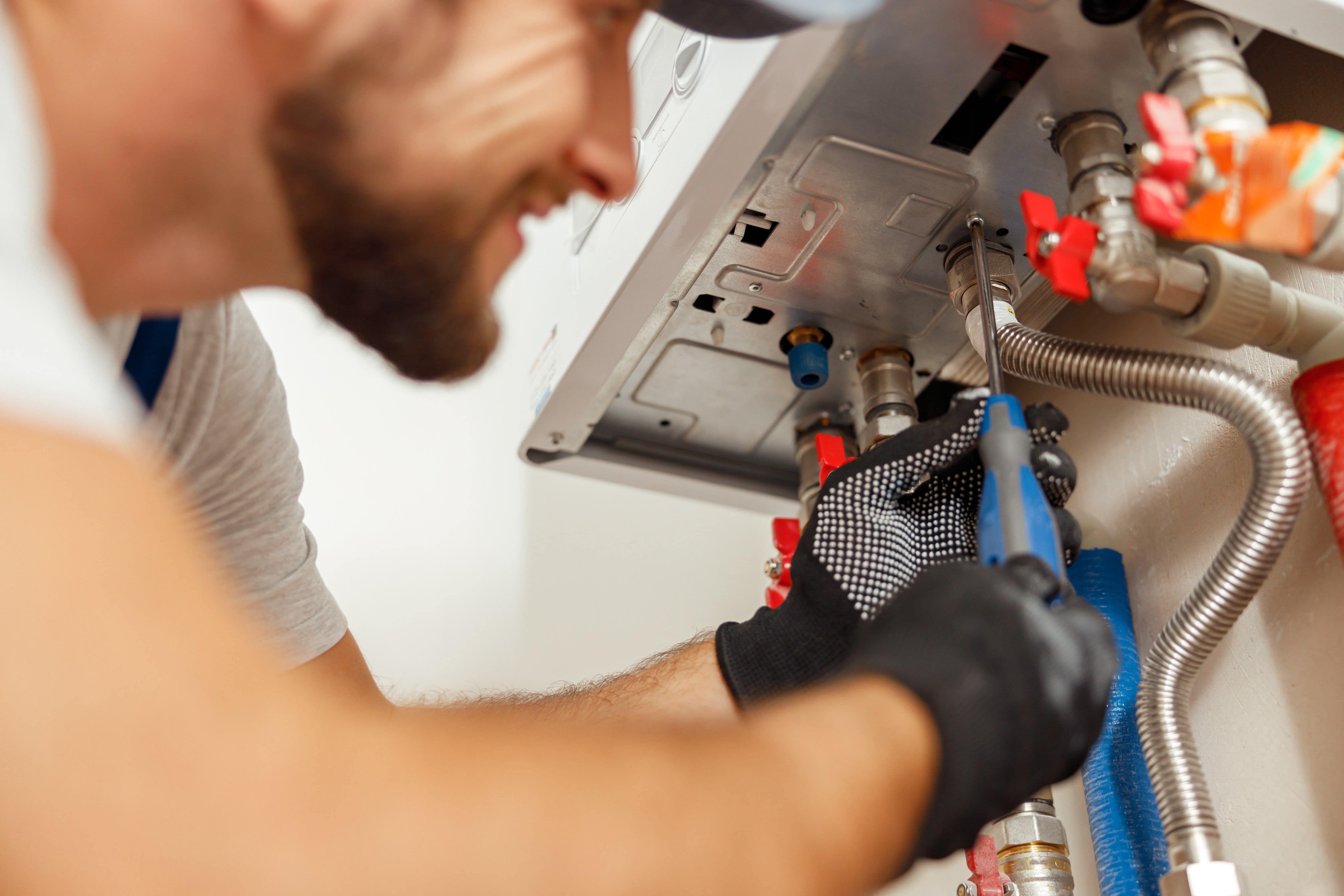 service technician working on boiler